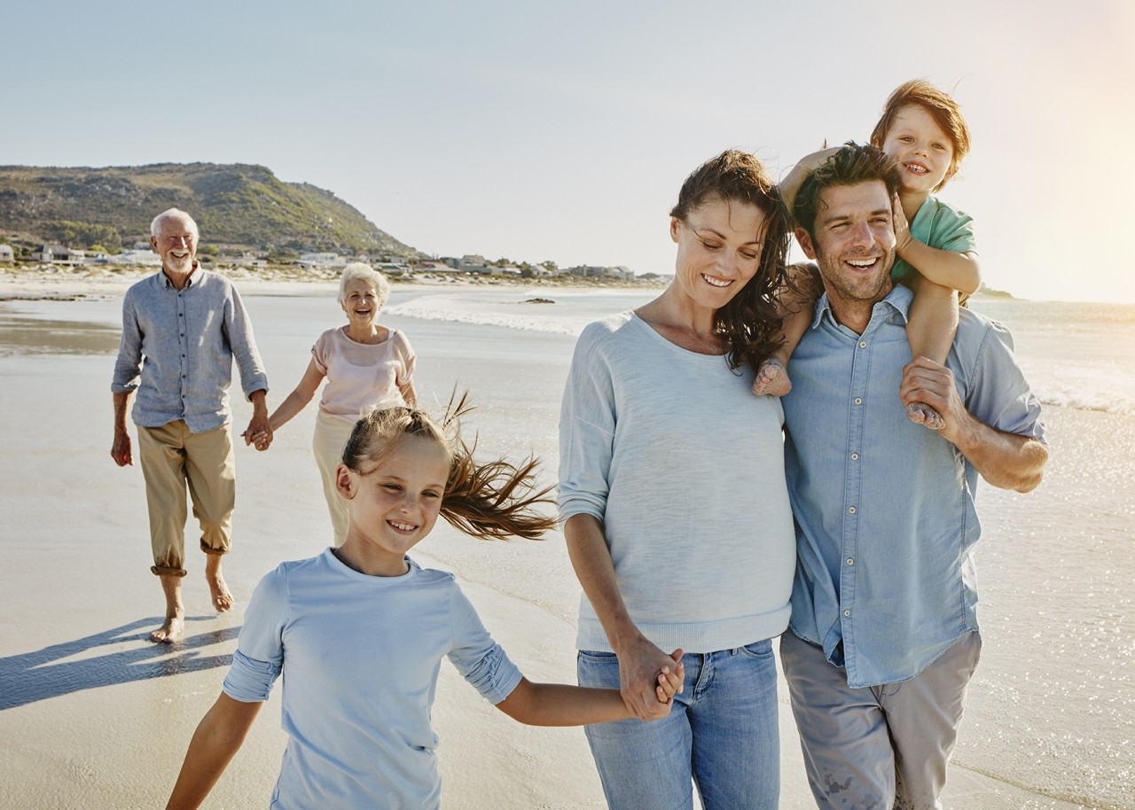 South Africa, Cape Town, three generations family strolling on the beach 